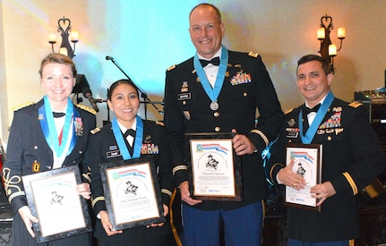 The Knowlton Award is awarded to select individuals who have demonstrated the high standards of integrity, moral character, professional competency and selflessness, and who have contributed significantly to the promotion of the Military Intelligence Corps. From left are award recipients Maj. Heather Richards, Maj. Melissa Tovar, Maj. Theodore Severn and Chief Warrant Officer 3 Frank Kuylen.

