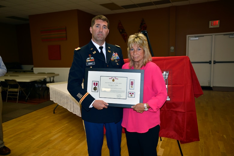 Lt. Col. Stephen Murphy, U.S. Army Corps of Engineers Nashville District commander, presents Debbie Ellis, wife of former U.S. Army Corps of Engineers Kentucky Lock resident engineer George A. (Tony) Ellis with a posthumous Superior Civilian Service Award. The US Highway 62 Bridge across the Tennessee River below Kentucky Dam was re-named in memory and in honor of May 30, 2017. (Photo by Mark Rankin)