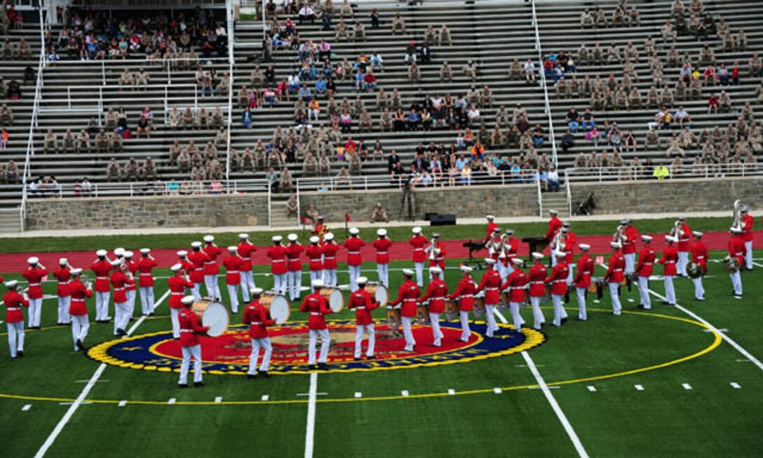 The Marine Corps Drum and Bugle Corps — “The Commandant’s Own” — perform on Butler Stadium’s brand new, artificial-turf field as the crowd at the stadium rededication ceremony looks on from the newly renovated bleachers in May 2012.