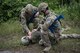 Senior Airman Jonah Phillips, 822d Base Defense Squadron fireteam member and Staff Sgt. Joshua Basinger, 822d BDS fireteam leader, check the vitals of an unconscious team member during a simulated explosives and hazardous material scenario, May 24, 2017, at Moody Air Force Base, Ga. The exercise was designed to simulate initial responses from first responders. Once on scene, they contacted other appropriate units after assessing the potential threat while also assisting the simulated victims of hazardous materials. (U.S. Air Force photo by Airman 1st Class Daniel Snider)