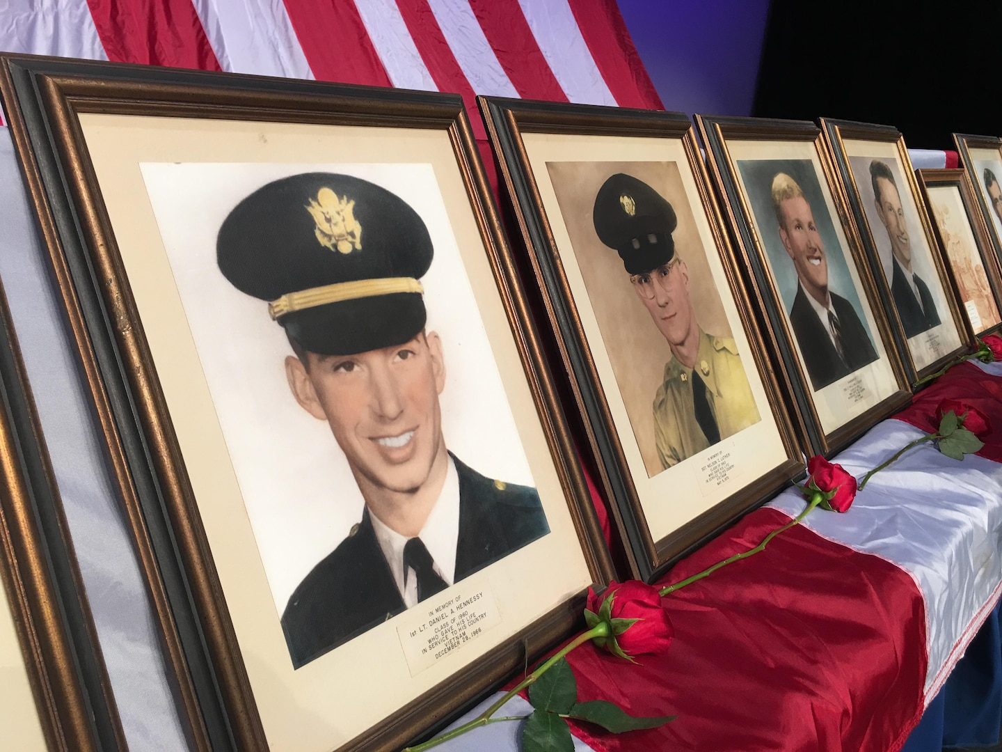 Portraits of the Council Rock 15 are displayed on stage during a Memorial Day ceremony May 26 at Council Rock North High School in Newtown, Pennsylvania. The portraits are of graduates of the school who lost their lives in U.S. armed conflicts, including Army Lt. Daniel A. Hennessey (foreground), Class of 1960, who was killed in Vietnam in 1966.