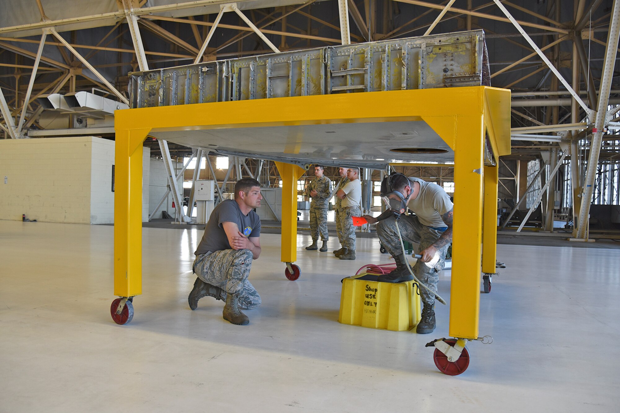 Senior Airman Nic Kueng, 92nd Maintenance Squadron isochronal inspection journeyman, removes a streamer from the inside of a training fuel cell during the 2017 Spring Maintenance Olympics May 26, 2017, at Fairchild Air Force Base. The moral event brings together various back shops from across the 92nd and 141st Maintenance Groups to work together and build camaraderie. (U.S. Air Force photo/Senior Airman Mackenzie Richardson)