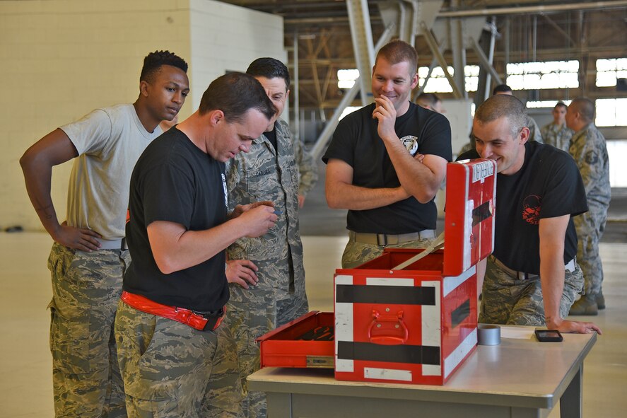 Team Raptor works on the third phase of the relay race during the 2017 Spring Maintenance Olympics May 26, 2017, at Fairchild Air Force Base. The third phase involved a toolbox and inspection forms with which the teams had to locate the various mistakes. (U.S. Air Force photo/Senior Airman Mackenzie Richardson)