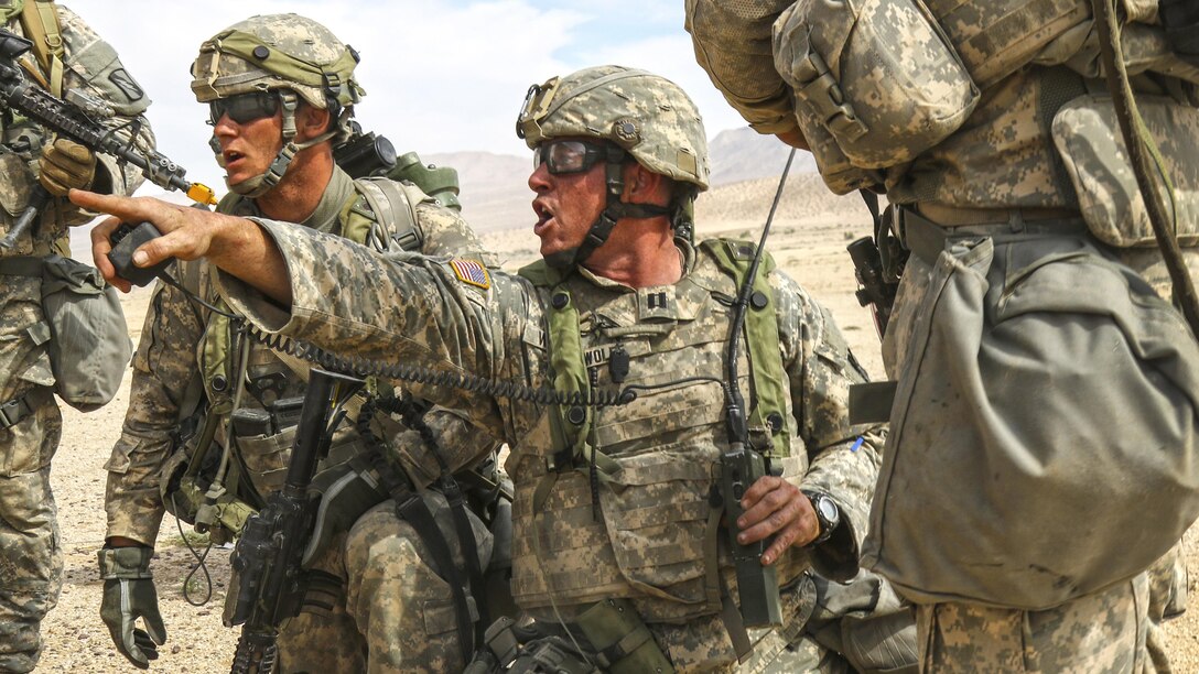 Army Capt. Andrew Wolfe issues orders to his unit during a combined arms assault exercise at the National Training Center at Fort Irwin, Calif., May 30, 2017. Wolfe is assigned to the Kansas Army National Guard’s Company C, 2nd Battalion, 137th Infantry Regiment. The Kansas unit is part of the 155th Armored Brigade Combat Team, Mississippi Army National Guard. Army National Guard photo by Staff Sgt. Shane Hamann