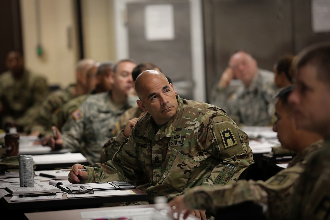 Command Sgt. Maj. Julio Alvarez, command sergeant major of 3rd Battalion, 348th Training Support Regiment, 177th Armored Brigade, takes in remarks shared between briefers and attendees during a New Command Teams Orientation held at 85th Support Command Headquarters in Arlington Heights, Ill., May 19-20, 2017. The orientation gave battalion command teams and Brigade Support Element staffs assigned to 85th Support Command, but operationally controlled by First Army, a better understanding of the practices and procedures that make up the hybrid relationship between First Army and the 85th SPT CMD.   
(U.S. Army photo by Master Sgt. Anthony L. Taylor)