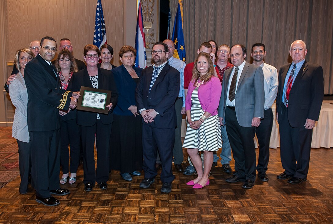 DLA Land and Maritime Deputy Commander and Federal Executive Association Chair James McClaugherty (right) presents the Team Innovation award to Land and Maritime’s Aircraft Launch and Recovery Equipment team during the May 24 FEA luncheon.