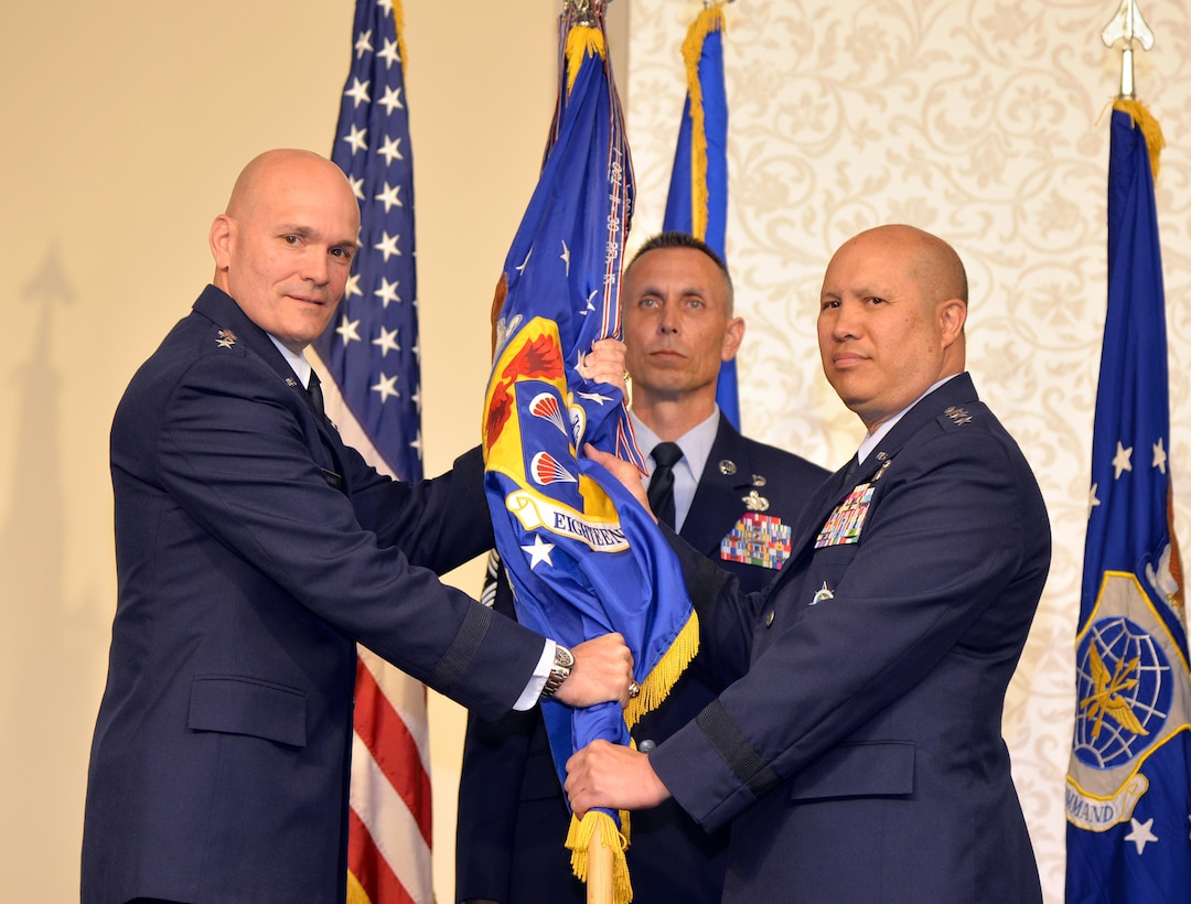 Gen. Carlton D. Everhart II, Air Mobility Command commander, passes the 18th Air Force guidon to Lt. Gen. Giovanni Tuck, the new 18th Air Force commander, during a change of command ceremony at the Scott Event Center, Scott Air Force Base, Illinois, June 1, 2017. Tuck comes to 18th Air Force from U.S. Transportation Command where he served as the Director of Operations and Plans. As 18th AF commander, Tuck is responsible for the command's worldwide operational mission of providing rapid global mobility and sustainment for America's armed forces through airlift, aerial refueling, aeromedical evacuation and contingency response. (U.S. Air Force photo by Master Sgt. Thomas J. Doscher)
