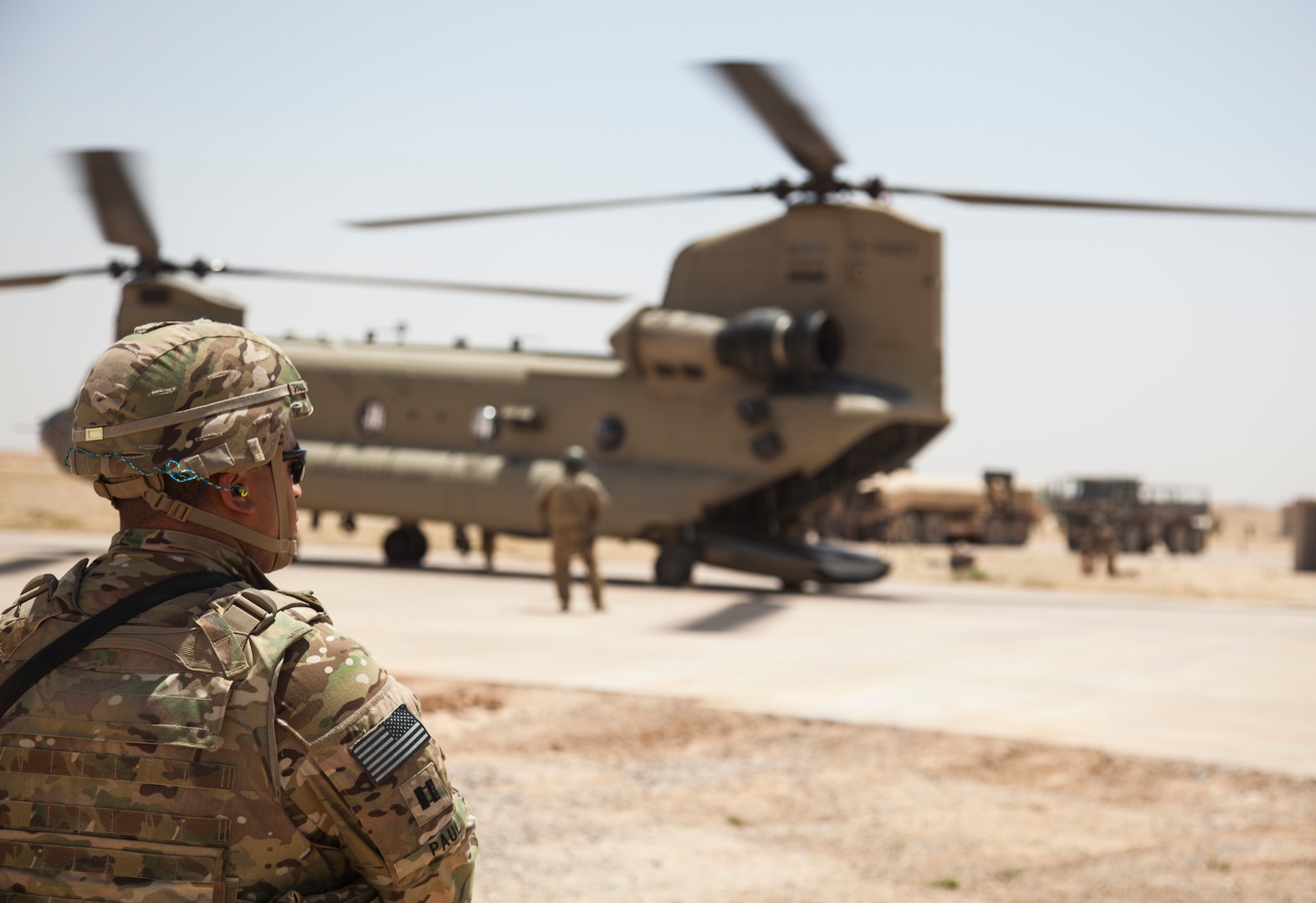 A U.S. soldier deployed in support of Combined Joint Task Force Operation Inherent Resolve waits while a CH-47 Chinook is refueled at Qayyarah West Airfield, Iraq, May 29, 2017. Army photo by Cpl. Rachel Diehm