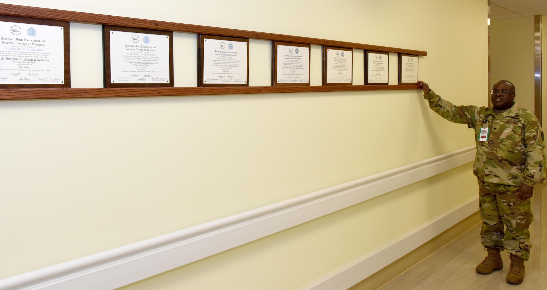 Col. (Dr.) Booker King places the latest American Burn Association and the American College of Surgeons reverification certificate next to previous certificates at the U.S. Army Institute of Surgical Research Burn Center.
