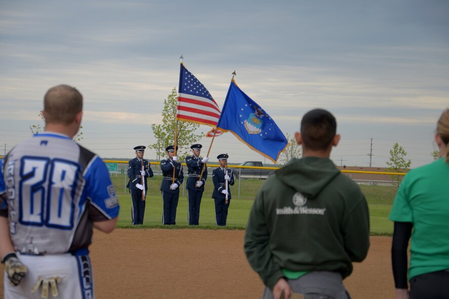 Minot Air Force Base Honor Guard presents the colors during the 3rd annual North Dakota military softball tournament at Roosevelt Park in Devils Lake N.D., May 25, 2017. This is the 3rd annual softball tournament that Minot and Grand Forks Air Force Base have competed in. (U.S. Air Force photo/Airman 1st Class Dillon Audit)