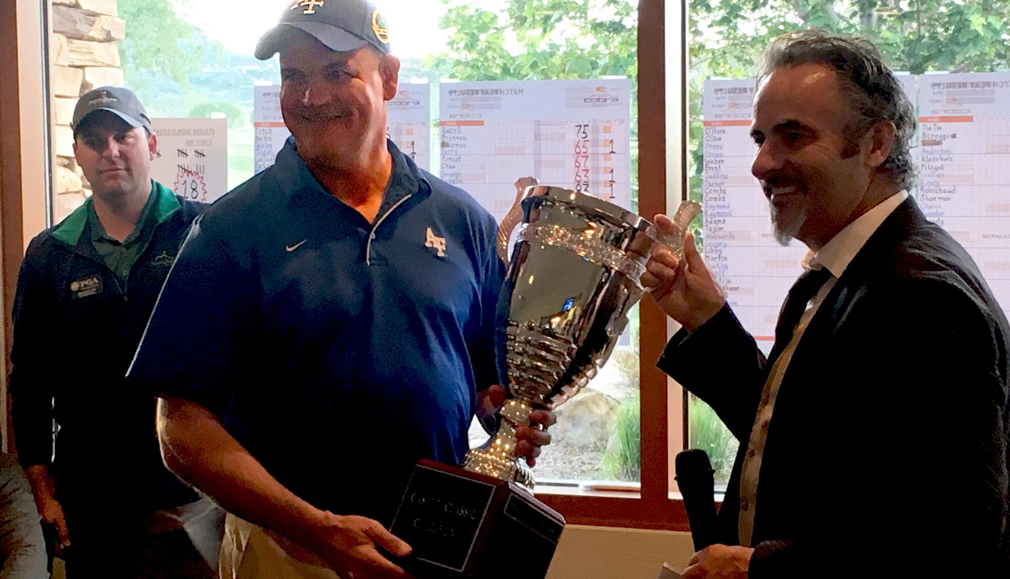 Col. Ken Ohlson, commander of the 10th Mission Support Group at the U.S. Air Force Academy, accepts a trophy from NBC and Golf Channel commentator David Feherty at the first annual CASTLE Classic golf tournament, May 26 at Cheyenne Shadows Golf Club, Fort Carson. The Academy beat Fort Carson 18-13 in the inaugural CASTLE Classic golf tournament May 26 at the club. (Courtesy photo)