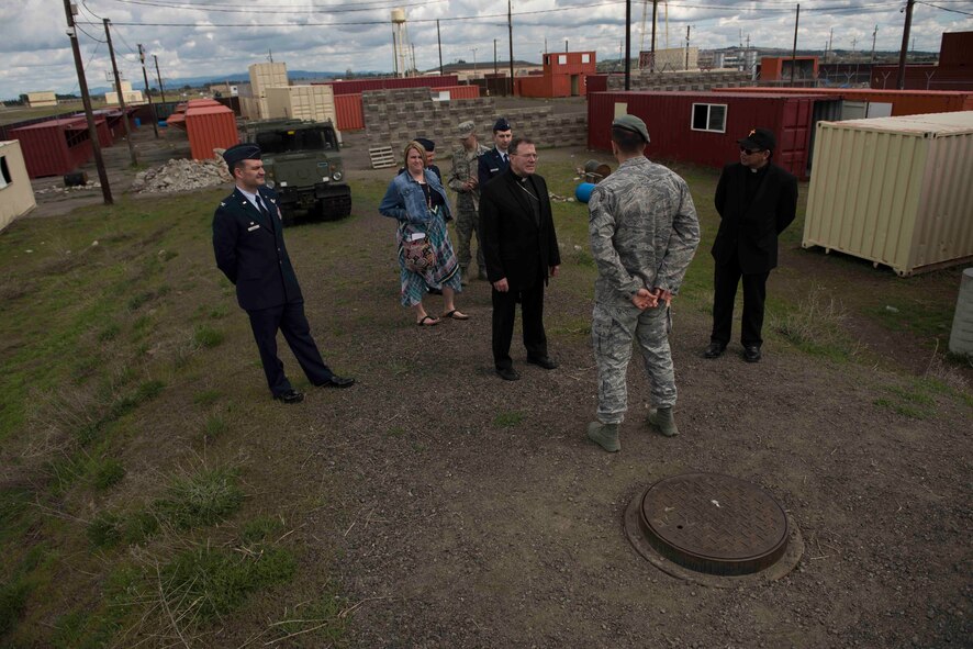 Bishop Neal Buckon, Archdiocese for Military Services auxiliary bishop, listens to Staff Sgt. Joseph Aguilera, 22nd Training Group survival instructor, while touring an urban training environment May 18, 2017, at Fairchild Air Force base, Washington. Bishop Buckon was shown the various simulated situations and training methods used to equip trainees with survival skills.
(U.S. Air Force Photo / Airman 1st Class Ryan Lackey)