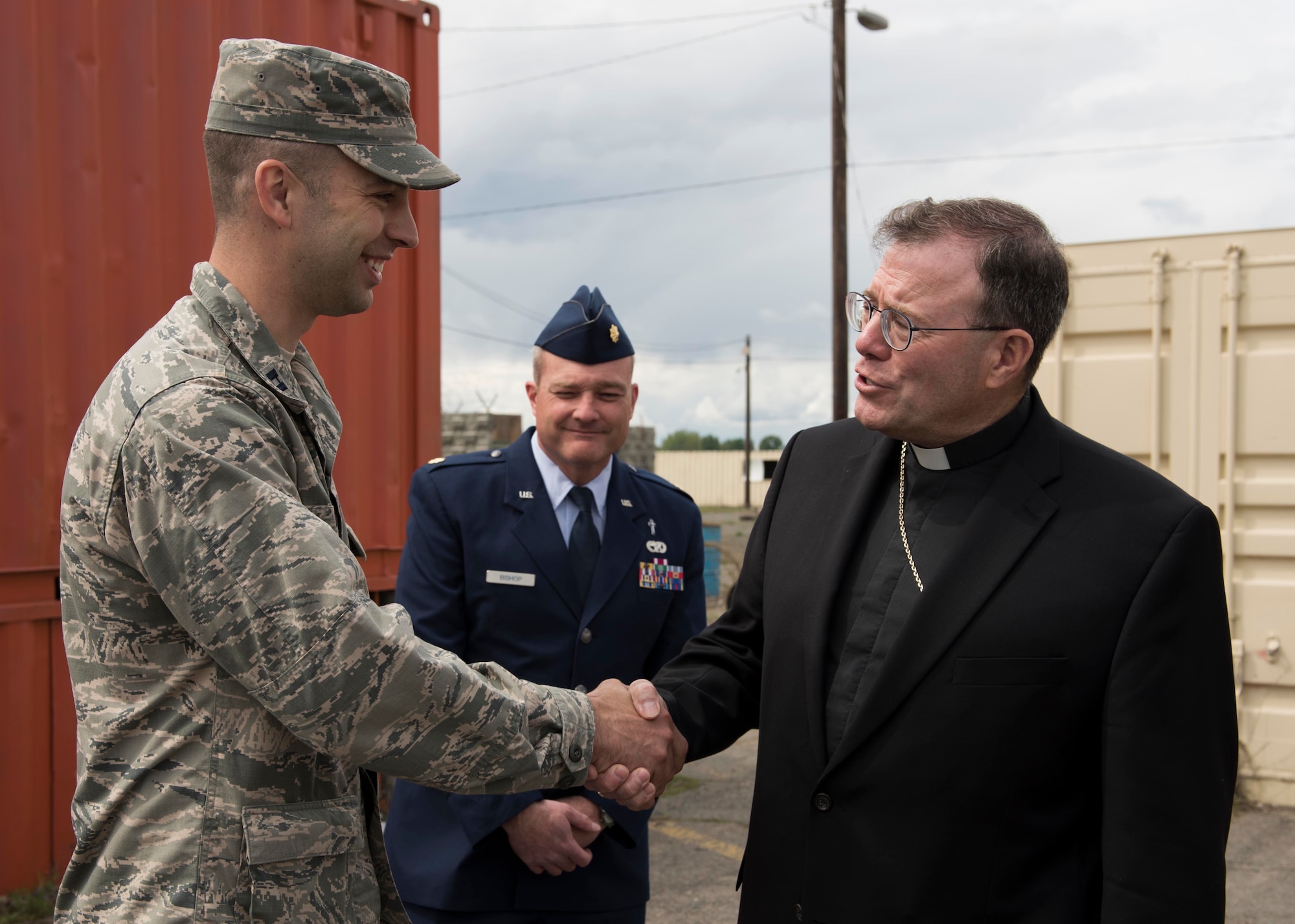 Bishop Neal Buckon, Archdiocese for Military Services auxiliary bishop and Maj. Shawn Bishop, 92nd Air Refueling Wing chaplain, thank Capt. Joshua Rumsey, 336th Training Group chaplain, for helping them tour the survival school May 18, 2017, at Fairchild Air Force Base, Washington. Bishop Buckon served as an officer twice before being ordained as a bishop, first as U.S. Army infantry and later entered the ministry and served as a chaplain. 
(U.S. Air Force Photo / Airman 1st Class Ryan Lackey)
