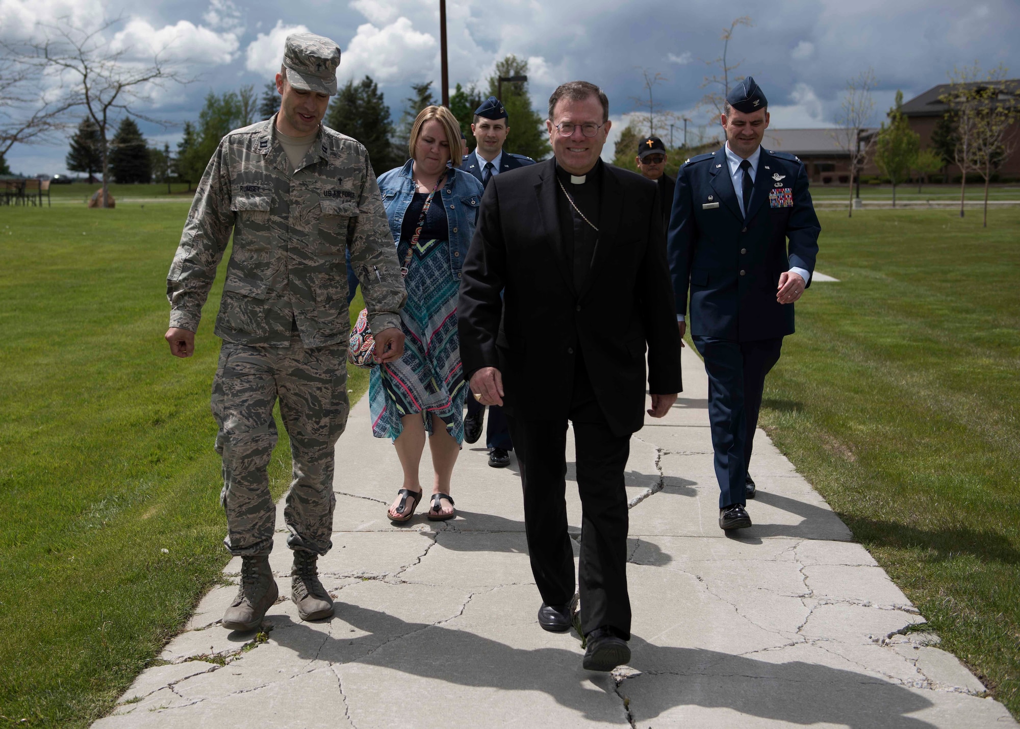 Capt. Joshua Rumsey, 336th Training Group chaplain (left) and Col. John Groves, 336th TRG commander (right), escort Bishop Neal Buckon, Archdiocese for Military Services auxiliary bishop, during a tour of the survival school facilities May 18, 2017 at Fairchild Air Force base, Washington. Bishop Buckon's military service decorations include the Legion of Merit, the Bronze Star, the Parachutist Badge and Ranger Tab. 
(U.S. Air Force Photo / Airman 1st Class Ryan Lackey)
