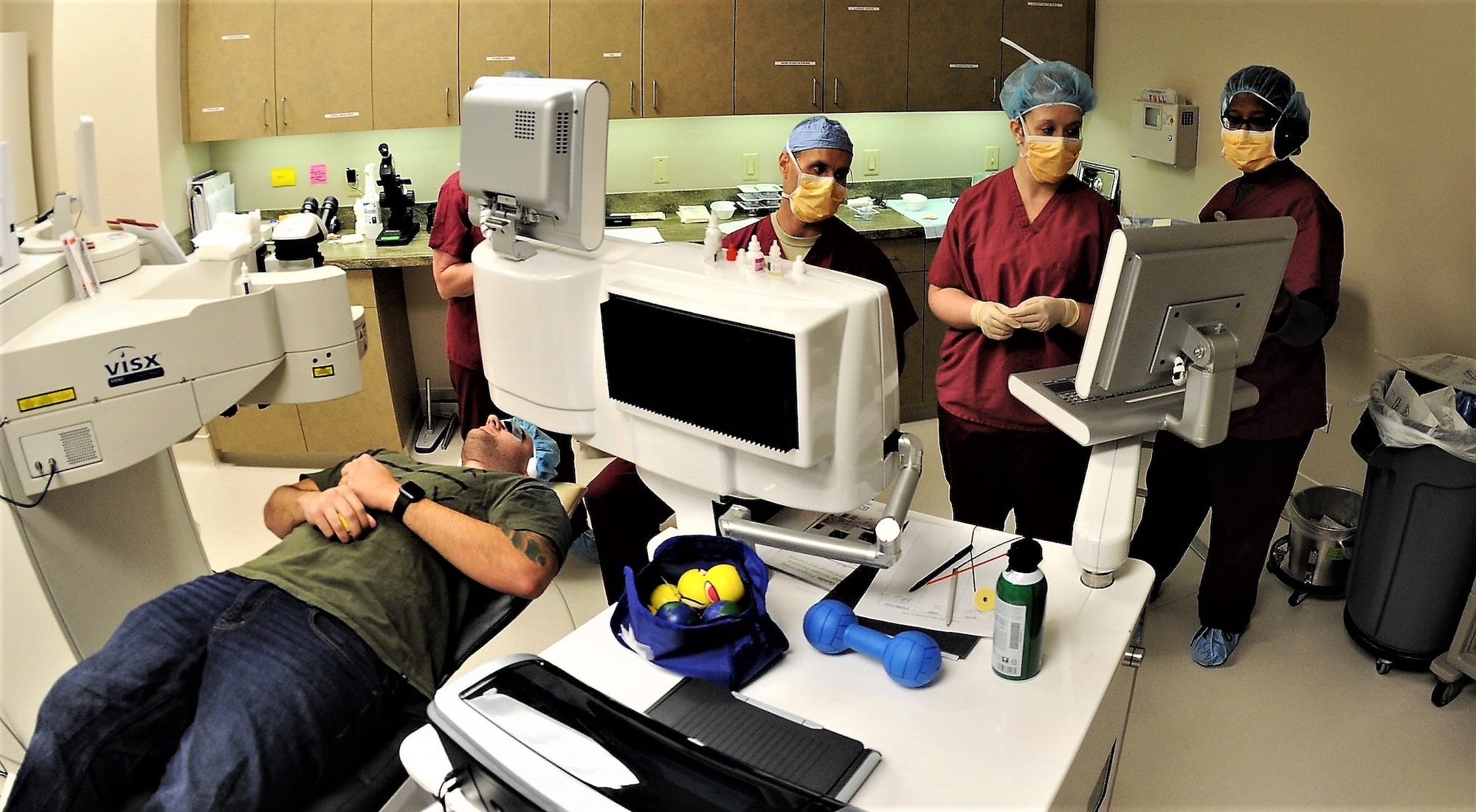 Staff Sgt. John Scacca, 633rd Medical Group, Joint Base Langley-Eustis (lying down), waits as Dr. Williams Gensheimer (sitting), 779th Medical Group’s Warfighter Eye Center chief, and his staff of refractive technicians verify patient data before beginning corneal refractive surgery May 17, 2017 at Joint Base Andrews, Md. JBA’s Warfighter Eye Center is one of only six of the Air Force’s corneal refractive surgery centers. (U.S. Air Force photo by Joe Yanik)