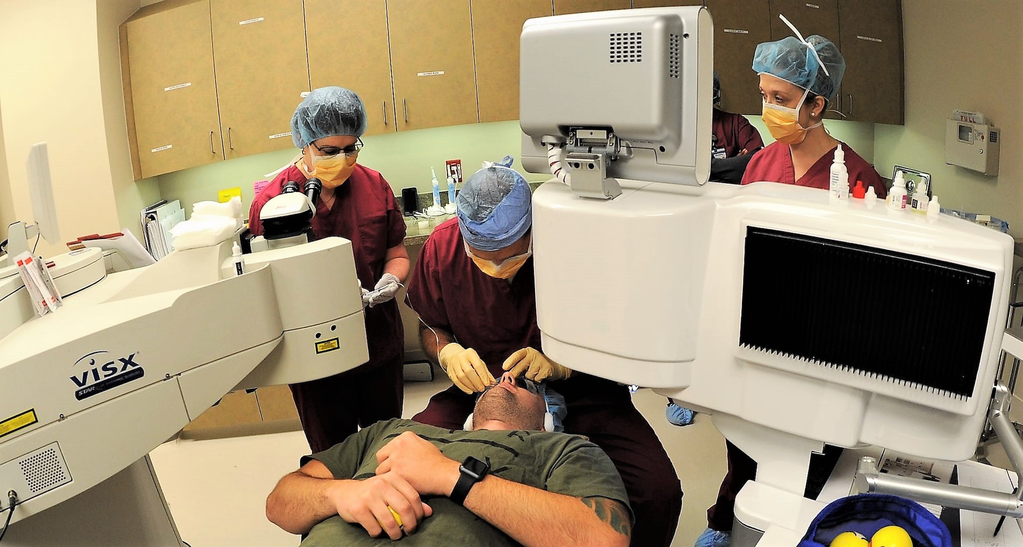 Dr. William Gensheimer (left), 779th Medical Group’s Warfighter Eye Center chief, places a lid speculum over one of a patient’s eyes May 17, 2017 at Joint Base Andrews, Md. It serves to force the patient’s eyelids to remain open while the laser re-shapes the cornea. (U.S. Air Force photo by Joe Yanik)
