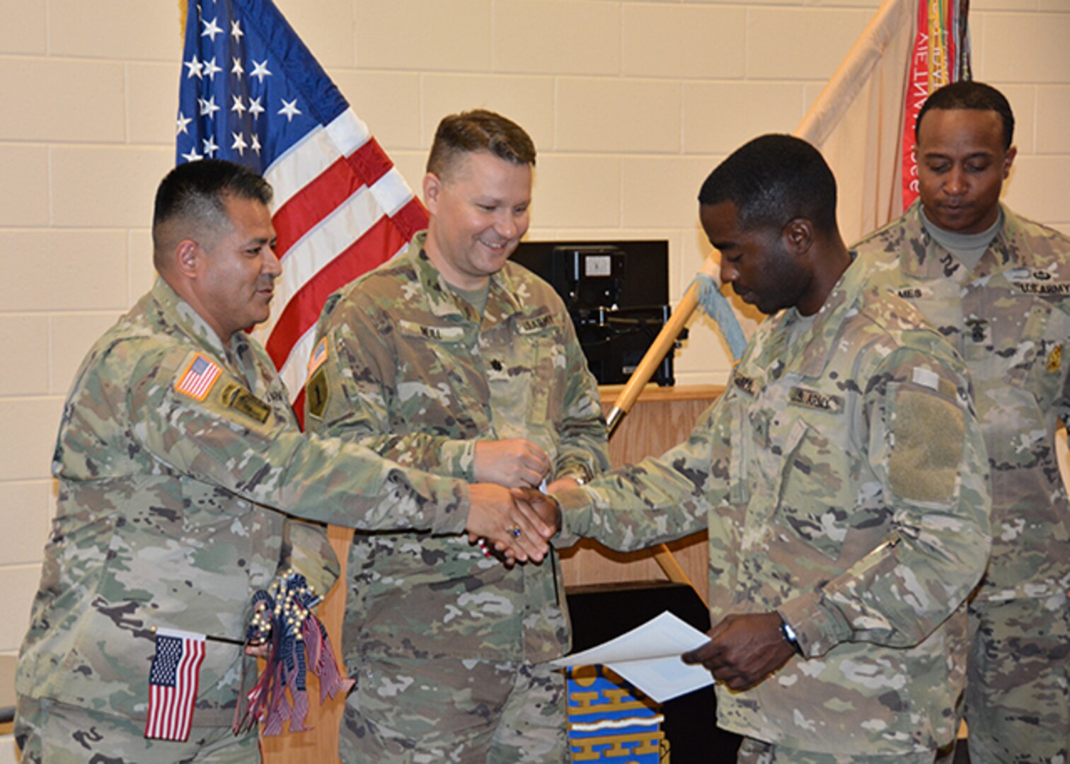 Defense Logistics Agency Aviation Army Maj.  Alex Shimabukuro shakes the hand of Army Private 1st Class Didier Martel Florestal, a native of Haiti, during his naturalization ceremony May 30, 2017 at Fort Lee, Virginia’s Soldier Support Center. Also pictured:  Army Lt. Col. Brian Neill, commander, 266th Quartermaster Battalion, center, and 266th Battalion Command Sergeant Major James Holmes, right.