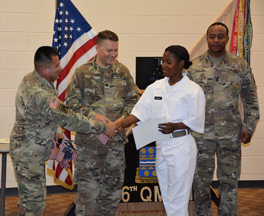 Defense Logistics Agency Aviation Army Maj. Alex Shimabukuro shakes the hand of Army Private Vennessa Baker, a native of Jamaica, during her naturalization ceremony May 30, 2017 at Fort Lee, Virginia’s Soldier Support Center. Also pictured:  Army Lt. Col. Brian Neill, commander, 266th Quartermaster Battalion, center, and 266th Battalion Command Sergeant Major James Holmes, right.