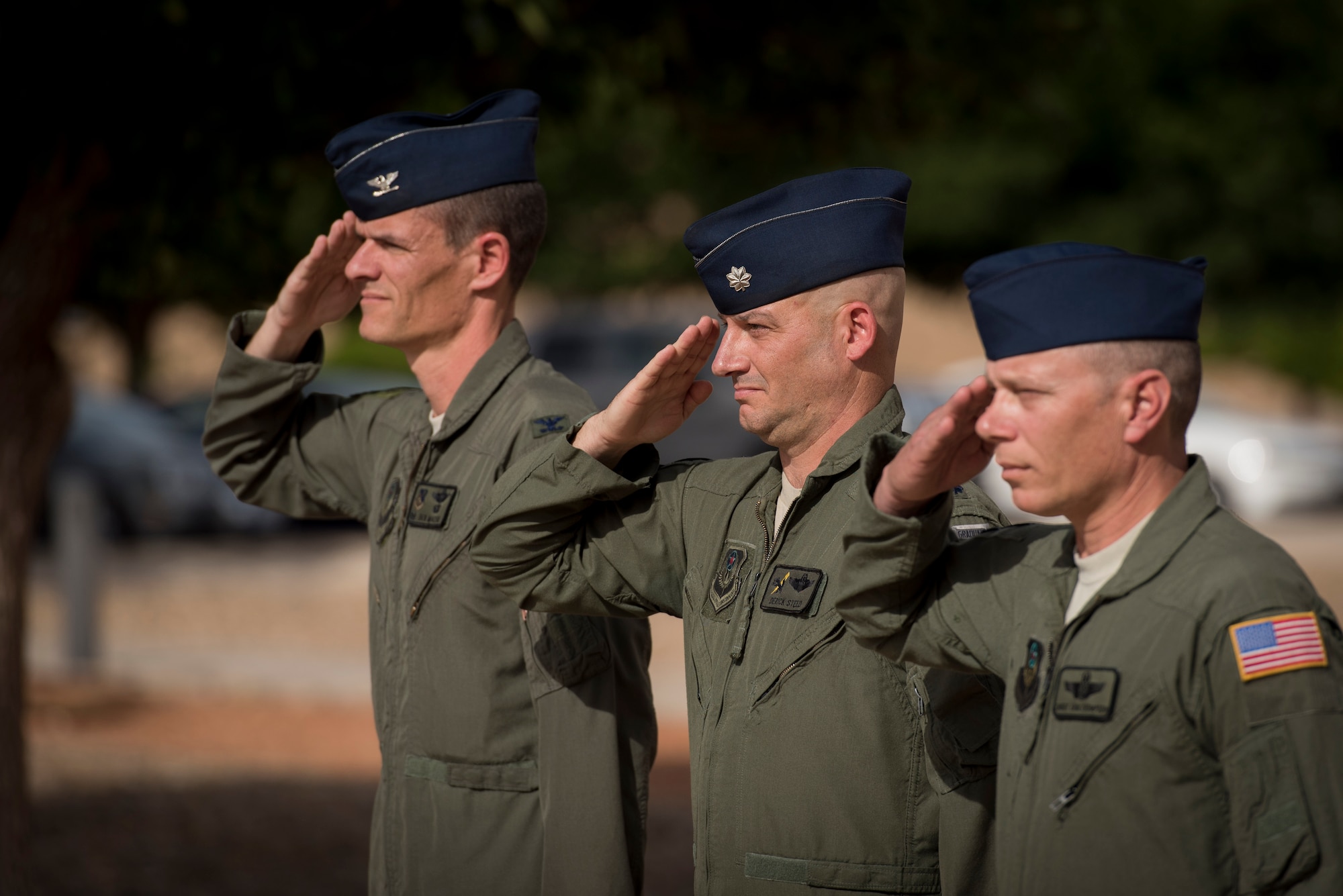 (Left) Col. Benjamin Maitre, 524th Special Operations Wing commander, (middle) Lt. Col. Derick Steed, 524th Special Operations Squadron commander, and Chief Master Sgt. Erik Thompson, 27 SOW command chief, salute during retreat at the 524 SOS end of mission ceremony on Cannon Air Force Base, N.M., May 31, 2017. The 524th is relocating to Duke Field, Florida, where the command will change hands from the 27th SOW to the 492nd SOW. The squadron has ties back to WWII, before it received its numerical designation of 524. (U.S. Air Force photo by Staff Sgt. Michael Washburn/Released)