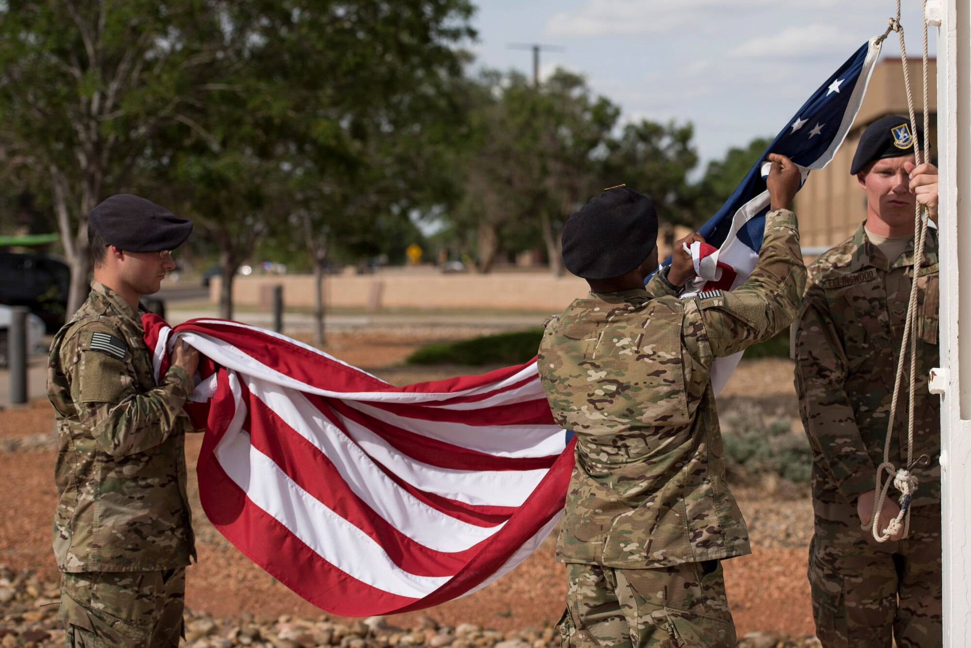 Members of the 27th Special Operations Security Forces Squadron lower the flag during retreat at the 524th Special Operations Squadron end of mission ceremony at Cannon Air Force Base, N.M., May 31, 2017. The 524th is relocating to Duke Field, Florida, where the command will change hands from the 27th SOW to the 492nd SOW. The 524th SOS has flown a wealth of aircraft throughout the years, including the B-18 Bolo, A-24 Banshee, P-47 Thunderbolt, F-82 Sabre, F-111 Aardvark, and the plane the squadron is currently flying: the C-146 Wolfhound. (U.S. Air Force photo by Staff Sgt. Michael Washburn/Released)