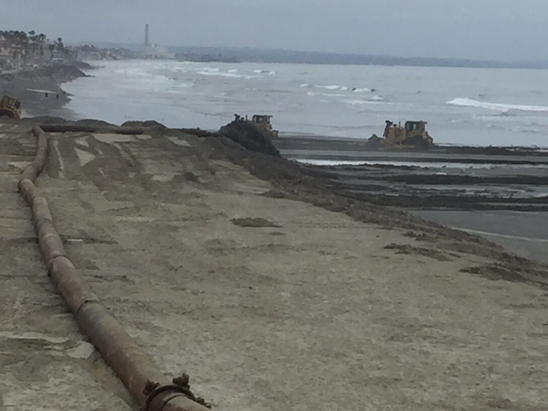 The anticipated placement of 420,000 cubic yards of beach quality sand along Oceanside's beaches is a beneficial byproduct of the annual Oceanside Harbor maintenance dredging project. Here, construction equipment contours sand south of the Oceanside Pier.