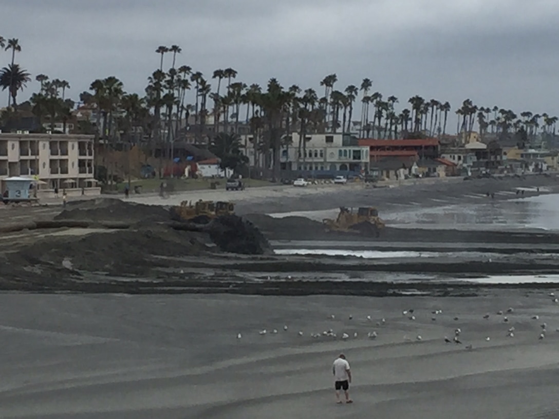 Construction equipment contours sand being discharged south of the Oceanside Pier as part of the annual Oceanside Harbor annual maintenance dredging project. The project, designed to provide safe navigation for military, commercial and private vessels that call the port home, is also a source of clean, beach-quality sand that enhances the city's recreation assets and increases protection for shoreline residences and business.