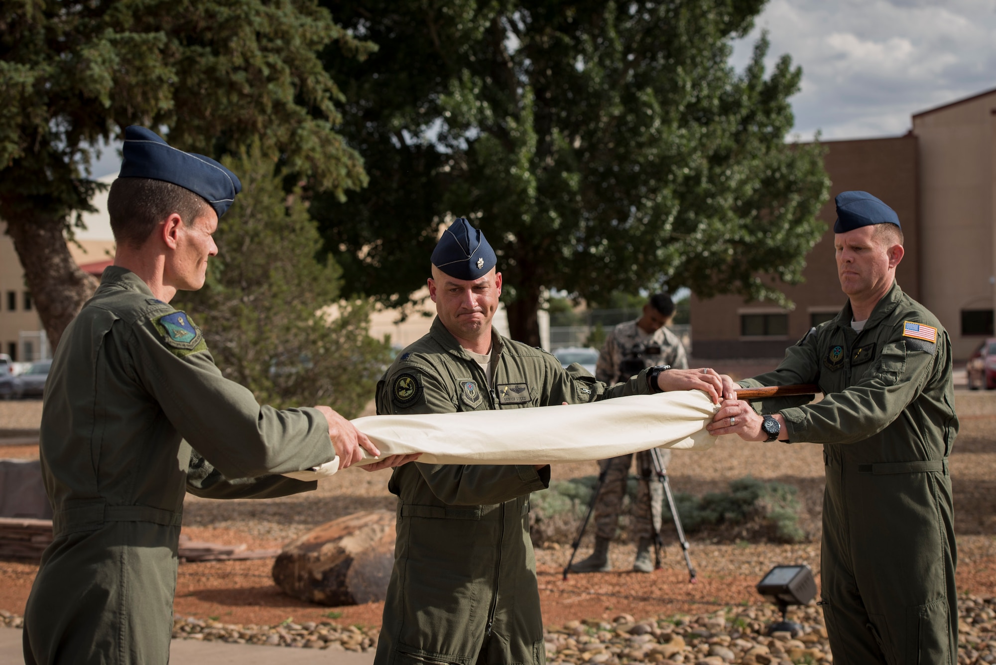 (Left) Col. Benjamin Maitre, 524th Special Operations Wing commander, (middle) Lt. Col. Derick Steed, 524th Special Operations Squadron commander, and Master Sgt. Chad Beach, 524 SOS first sergeant, ceremoniously cover the guidon during the 524 SOS end of mission ceremony at Cannon Air Force Base, N.M., May 31, 2017. The 524th is relocating to Duke Field, Florida, where the command will change hands from the 27th SOW to the 492nd SOW. The squadron has ties back to WWII, before it received its numerical designation of 524. (U.S. Air Force photo by Staff Sgt. Michael Washburn/Released)