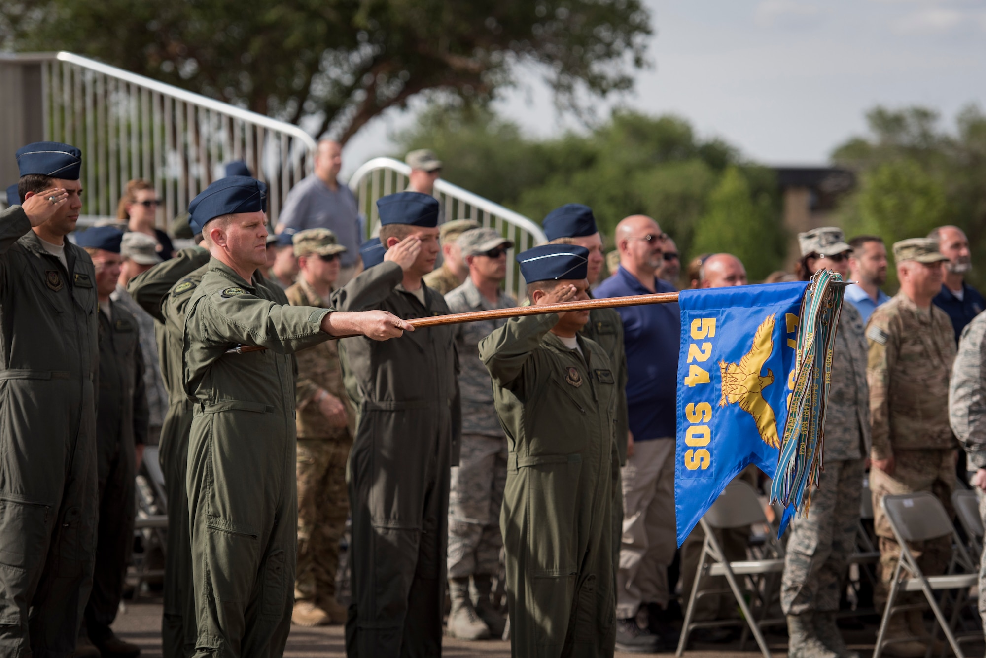 Members of the 524th Special Operations Squadron render salutes during an end of mission ceremony at the 27th Special Operations Wing building May 31, 2017 at Cannon Air Force Base, N.M. The 524th is relocating to Duke Field, Florida, where the command will change hands from the 27th SOW to the 492nd SOW. The ceremony is also historical as the 524th is the last remaining squadron on the base that has original ties to the 27th SOW. (U.S. Air Force photo by Staff Sgt. Michael Washburn/Released)