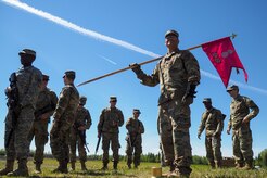 Army Sgt. Michael Garcia, a native of Yabucoa, P.R., holds his company guidon as Soldiers assigned to the 98th Support Maintenance Company, 17th Combat Sustainment Support Battalion, U.S. Army Alaska, to conduct known distance marksmanship at Pedneau range on Joint Base Elmendorf-Richardson, Alaska, May 31, 2017.  The SMC is a modular maintenance company that provides field maintenance support on an area basis to units in the form of allied trades support; wheeled vehicle recovery; armament; communications; electronics; special electronic devices; ground support equipment; power generation equipment; utility equipment; and test, measurement, and diagnostic equipment maintenance and quality control.