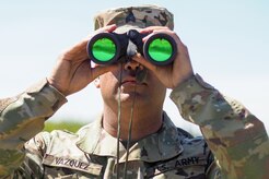 Army Sgt. Elvin Vasquez, a native of Caguas, P.R., uses binoculars to observe targets down range as Soldiers assigned to the 98th Support Maintenance Company, 17th Combat Sustainment Support Battalion, U.S. Army Alaska, conduct known distance marksmanship at Pedneau range on Joint Base Elmendorf-Richardson, Alaska, May 31, 2017.  The SMC is a modular maintenance company that provides field maintenance support on an area basis to units in the form of allied trades support; wheeled vehicle recovery; armament; communications; electronics; special electronic devices; ground support equipment; power generation equipment; utility equipment; and test, measurement, and diagnostic equipment maintenance and quality control.