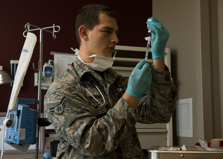 Airman 1st Class Christian Beserra, 92nd Aerospace Medical Squadron aerospace medical technician, fills a syringe in preparation for a patient May 26, 2017, at Fairchild Air Force Base, Washington. Medical technicians assist doctors in prepping equipment and assisting with medical procedures.