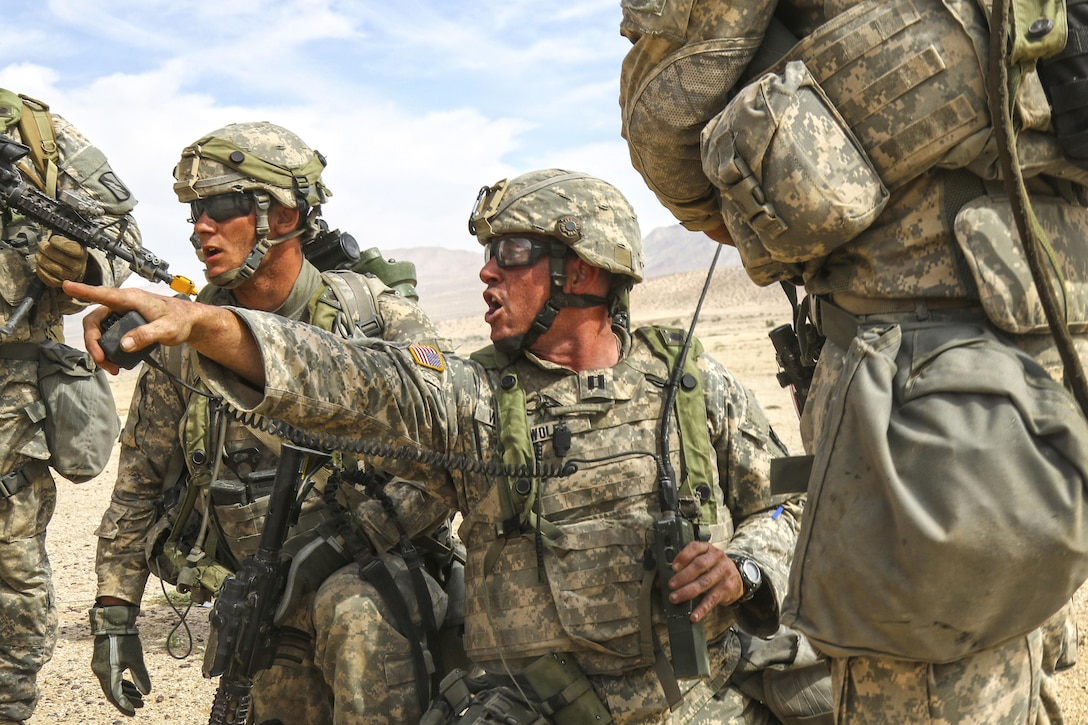 Army Capt. Andrew Wolfe issues orders to his unit during a combined arms assault exercise at the National Training Center at Fort Irwin, Calif., May 30, 2017. Wolfe is assigned to the Kansas Army National Guard’s Company C, 2nd Battalion, 137th Infantry Regiment. The Kansas unit is part of the 155th Armored Brigade Combat Team, Mississippi Army National Guard. Army National Guard photo by Staff Sgt. Shane Hamann