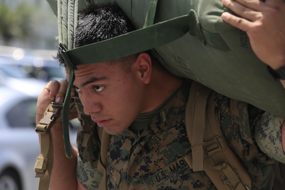 Cpl. Hugo Mendez, a rifleman with Lima Company, Battalion Landing Team 3rd Battalion, 5th Marines, 31st Marine Expeditionary Unit, carries a sea bag after arriving at Camp Hansen, Okinawa, Japan, May 11, 2017. BLT 3/5 replaced BLT 2/5 as the Ground Combat Element of the 31st MEU. As the Marine Corps’ only continuously forward-deployed unit, the 31st MEU air-ground-logistics team provides a flexible force, ready to perform a wide range of military operations, from limited combat to humanitarian assistance operations, throughout the Indo-Asia-Pacific region. (U.S. Marine Corps photo by Lance Cpl. Stormy Mendez)