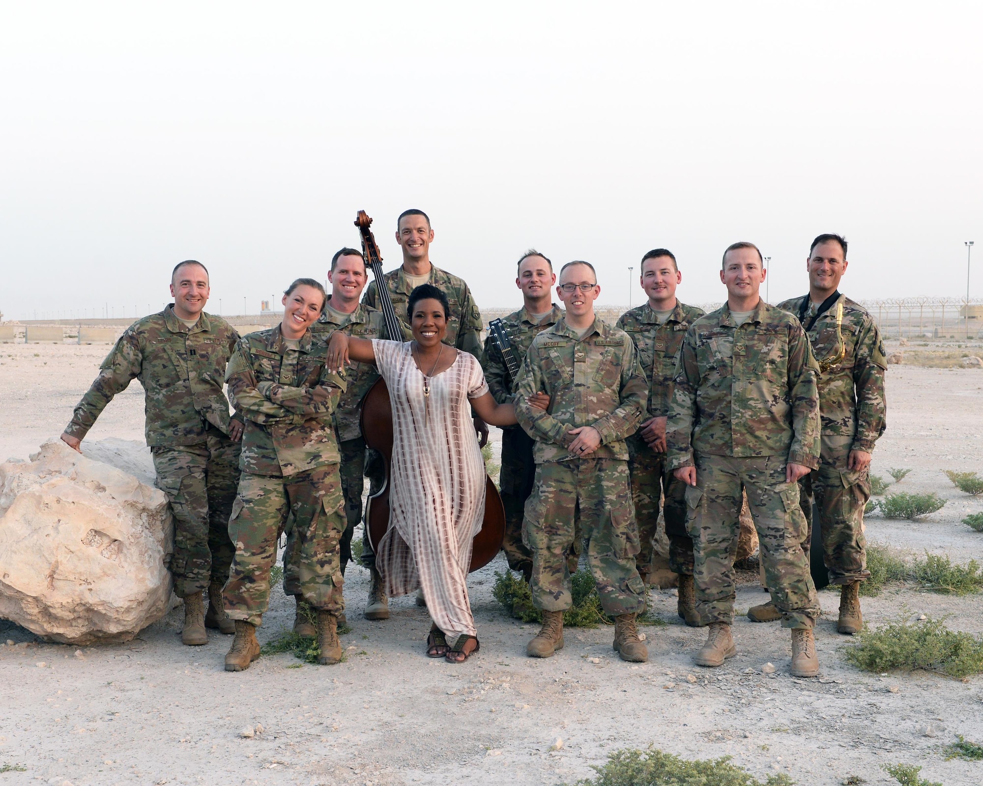 Members of the Air Forces Central Command Band pose for a photograph with Melinda Doolittle, an accomplished vocalist and top finisher on American Idol, following a practice session held at an outside venue in preparation for a concert at Al Udeid Air Base, Qatar, May 25, 2017. Doolittle performed for service members deployed overseas, accompanied by the Air Forces Central Command Band. (U.S. Air Force photo by Tech. Sgt. Bradly A. Schneider/Released)