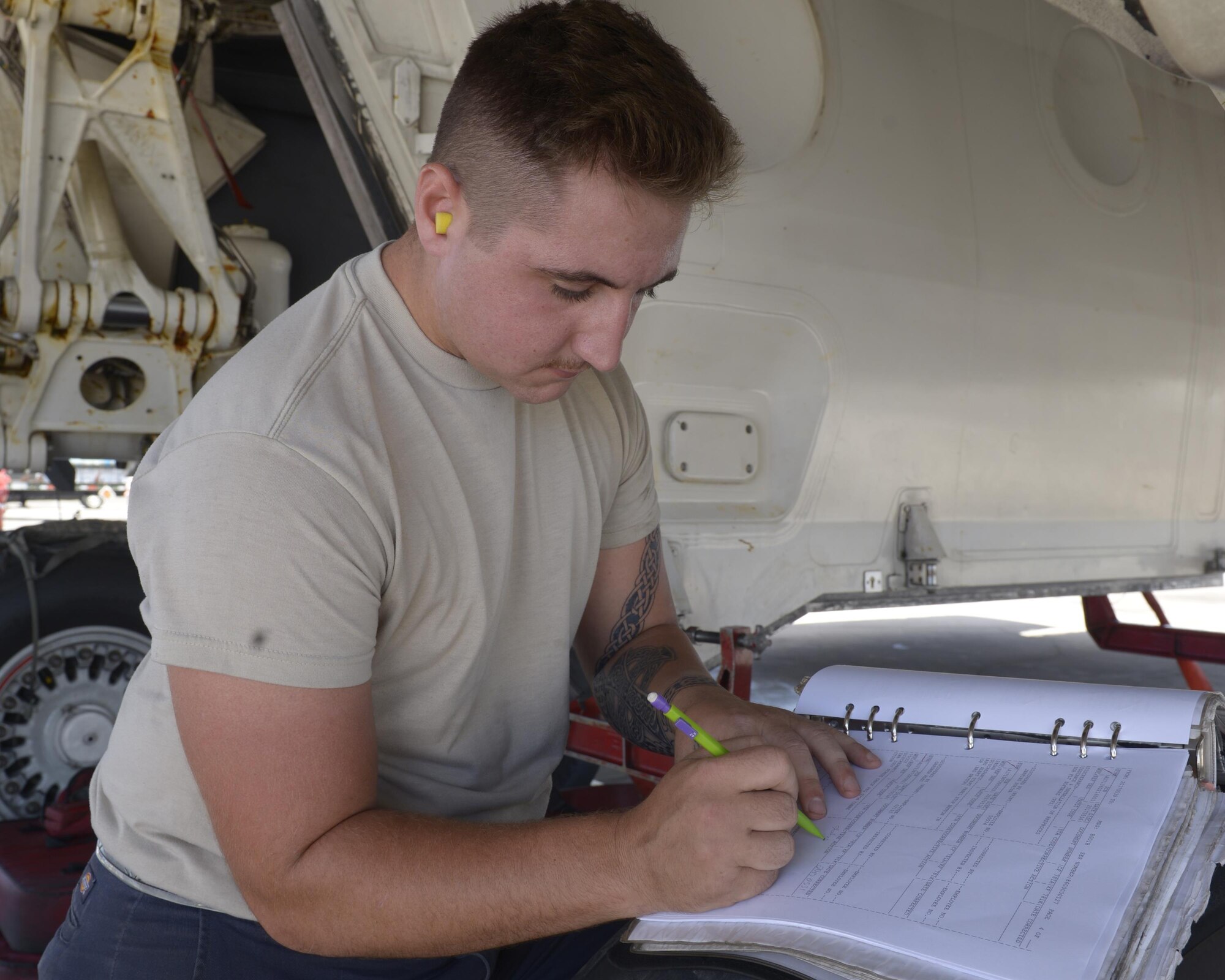 An Airman with the 36 Expeditionary Aircraft Maintenance Squadron annotates in an aircraft maintenance forms as he and his team load munitions into a B-1B Lancer May 31, 2017, at Andersen Air Force Base Guam. The team is deployed here from Dyess AFB, Texas, in support of Pacific Command’s Continuious Bomber Presence mission. (U.S. Air Force photo by Senior Airman Cierra Presentado/Released)