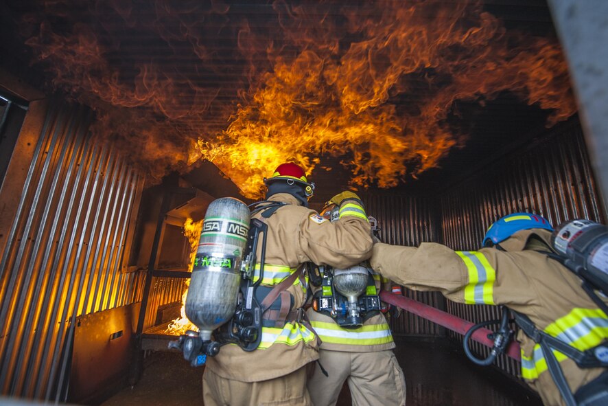 U.S. Air Force firefighters from the 8th Civil Engineer Squadron, Kunsan Air Base, 51st Civil Engineer Squadron, Osan Air Base, and Republic of Korea Air Force firefighters, spray water at a fire during combined fire training at Kunsan Air Base, Republic of Korea, May 23, 2017. U.S. and ROKAF firefighters trained together to help bridge communication gaps and improve their efficiency in responding to real-world scenarios. (U.S. Air Force photo by Senior Airman Colville McFee/Released)