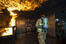 U.S. Air Force firefighters from the Kunsan Air Base 8th Civil Engineer Squadron, Osan Air Base 51st Civil Engineer Squadron, and Republic of Korea Air Force firefighters enter a live fire room during combined fire training at Kunsan Air Base, Republic of Korea, May 23, 2017. The firefighters, who were broken up into small teams, were able to test their ability to extinguish structural fires during the training. U.S. and ROKAF firefighters used the training to help bridge communication gaps and improve their efficiency in responding to real-world scenarios. (U.S. Air Force photo by Senior Airman Colville McFee/Released)