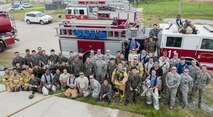 U.S. Air Force firefighters from the Kunsan Air Base 8th Civil Engineer Squadron, Osan Air Base 51st Civil Engineer Squadron, and Republic of Korea Air Force firefighters take a group photograph during a combined fire training on Kunsan Air Base, Republic of Korea, May 23, 2017. U.S. and ROKAF firefighters spent the day training together to help bridge communication gaps and improve their efficiency in responding to real-world scenarios. (U.S. Air Force photo by Senior Airman Colville McFee/Released)