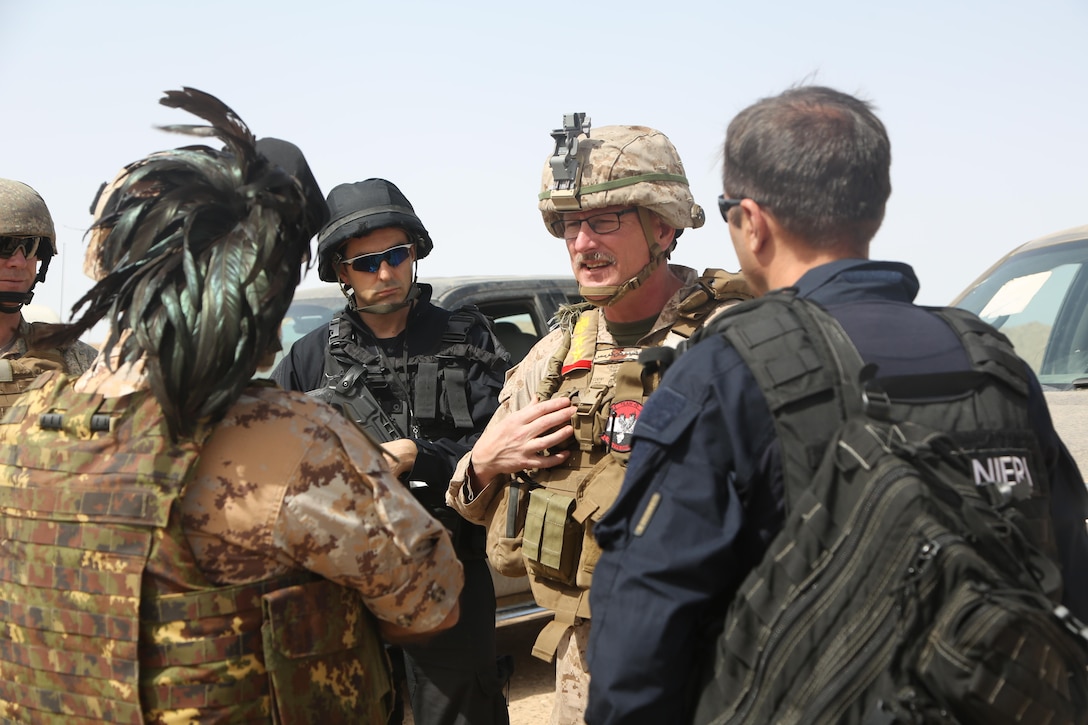 U.S. Marine Corps Col. Christian Cabaniss, the commander of Task Force Al Taqaddum and deployed in support of Combined Joint Task Force – Operation Inherent Resolve, speaks with Italian police officials   about the current and future training plans for the Iraqi police and military forces on Al-Taqaddum Air Base, Iraq, April 27, 2017. Deploying U.S. Marines into the U.S. Central Command area of responsibility to conduct combined military training with our partner nations’ security forces strengthens our vital relationships with partners in this strategically important region. This training is part of the overall CJTF-OIR building partner capacity mission by training and improving the capability of partnered forces fighting ISIS. CJTF-OIR is the global Coalition to defeat ISIS in Iraq and Syria.  