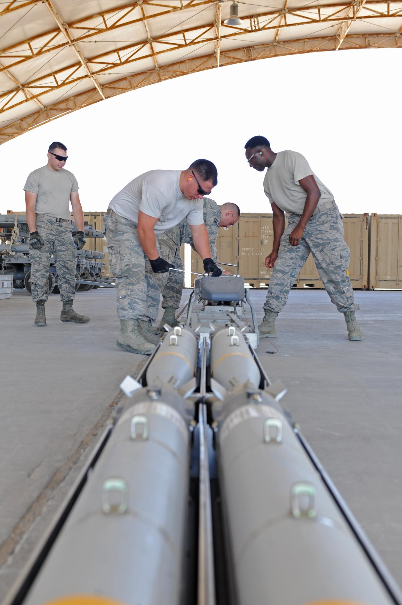 Airmen with the 380th Expeditionary Maintenance Squadron munitions flight prepare small diameter munitions at an undisclosed location in southwest Asia, May 26, 2017. Munitions Airmen recently helped to set a record of SDMs dropped by an F-22 Raptor squadron in a single month, letting loose 84 of them in support of the fight against the Islamic State group. (U.S. Air Force photo by Staff Sgt. Marjorie A. Bowlden)