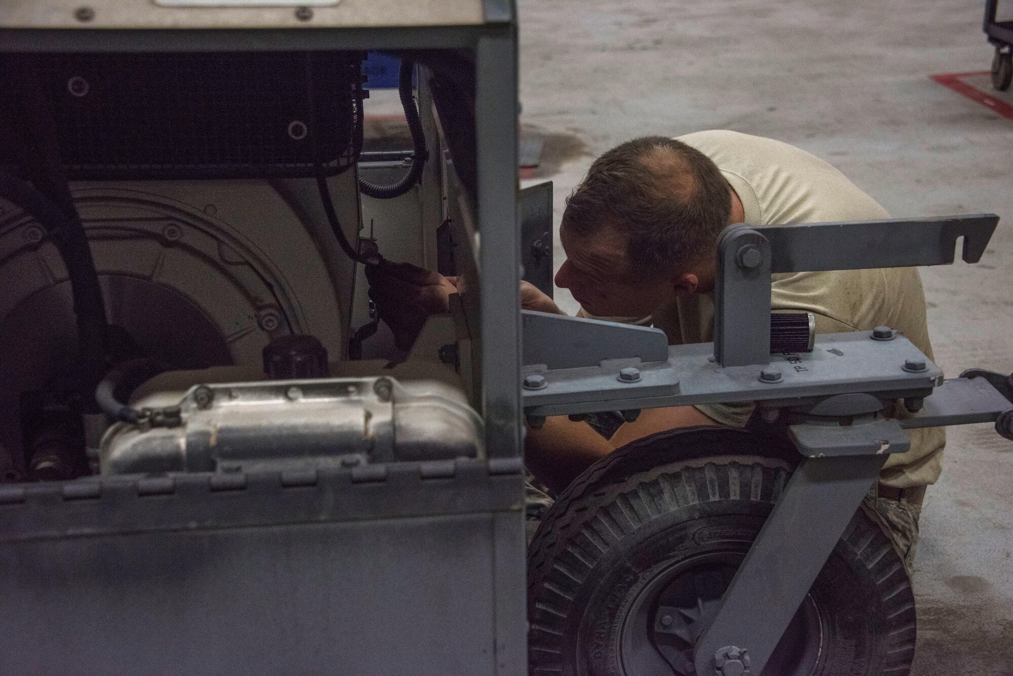 Senior Airman Jacob Franz, a 386th Expeditionary Aircraft Maintenance Squadron aerospace ground equipment technician, conducts maintenance on a Hydro Mite landing gear strut service stand at an undisclosed location in Southwest Asia, May 7, 2017. The 15-member flight maintains and repairs more than 130 pieces of aerospace ground equipment to fit the demands of the airpower mission, including generators, air conditioners, hydraulic test stands and nitrogen servicing. (U.S. Air Force photo/Tech. Sgt. Jonathan Hehnly)  