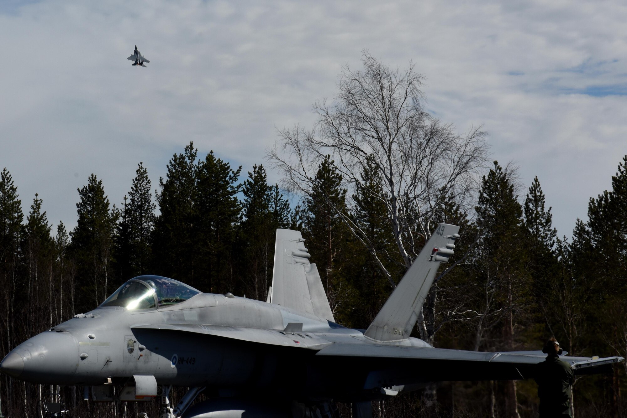 A 493rd Fighter Squadron F-15C Eagle from the 48th Fighter Wing at Royal Air Force Lakenheath, England takes off in the distance behind a Finnish F/A-18 Hornet at Rovaniemi Air Base, Finland, May 25, in support of Arctic Challenge 2017. Multinational exercises like ACE 17 are opportunities for the U.S. to strengthen relationships with European allies and partners. (U.S. Air Force photo/Airman 1st Class Abby L. Finkel)