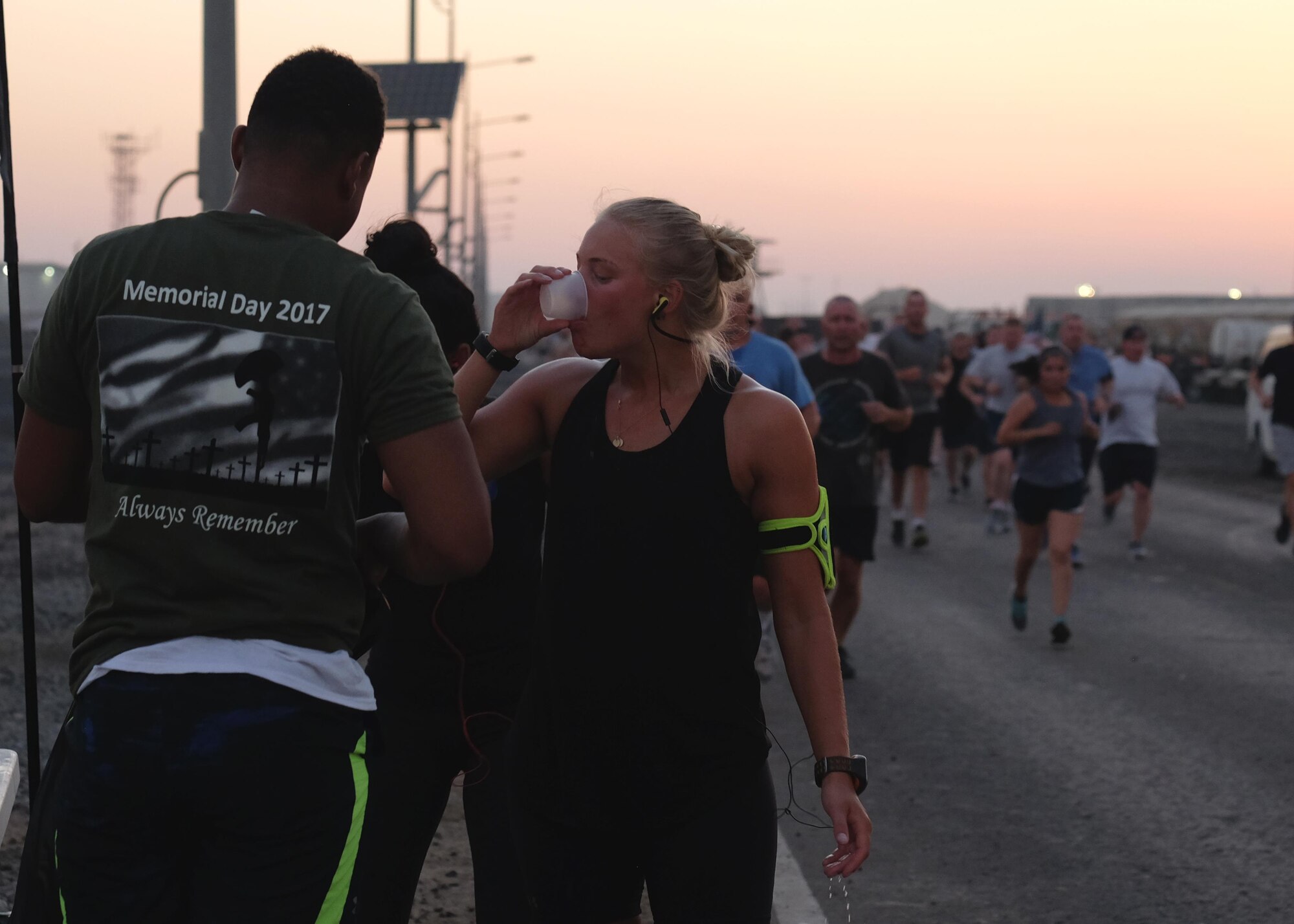 An Airman with the 380th Air Expeditionary Wing hydrates during a Memorial Day 5-km run May 29, 2017, at an undisclosed location in southwest Asia. The run served as an opportunity for all service members on base to join together and remember their fallen comrades. (U.S. Air Force photo by Senior Airman Preston Webb)