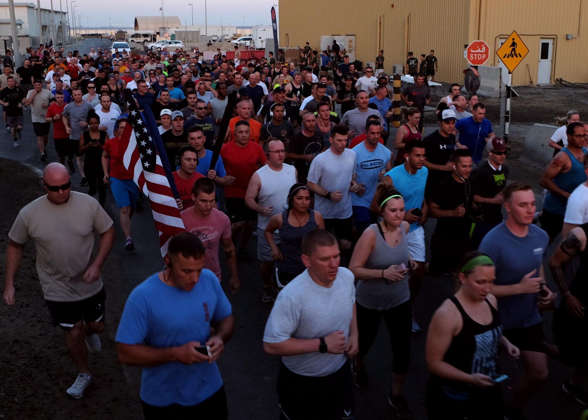 Airmen with 380th Air Expeditionary Wing and Coalition Partners jog during a Memorial Day 5-km run May 29, 2017, at an undisclosed location in southwest Asia. Airmen on base gathered together in honor of fallen comrades for this 5-km run. (U.S. Air Force photo by Senior Airman Preston Webb)