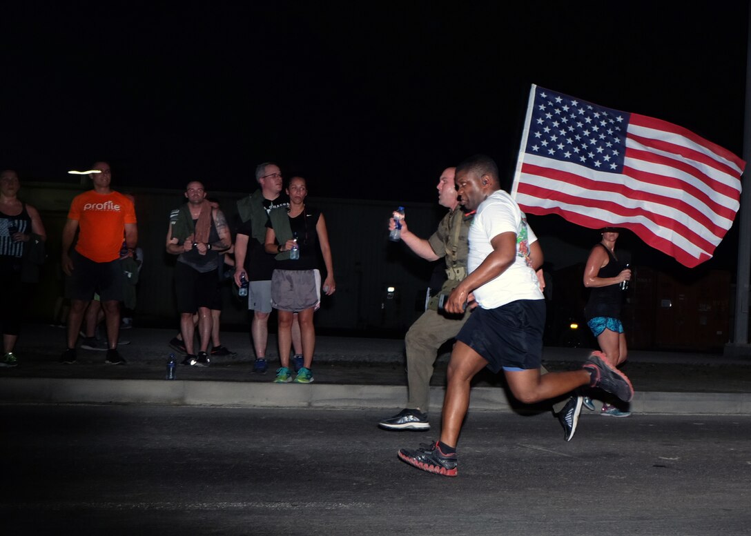 An Airmen with the 380th Air Expeditionary Wing sprint to the finish of a 5-km Memorial Day run May 29, 2017, at an undisclosed location in southwest Asia. The run served as an opportunity for all service members on base to join together and remember their fallen comrades. (U.S. Air Force photo by Senior Airman Preston Webb)