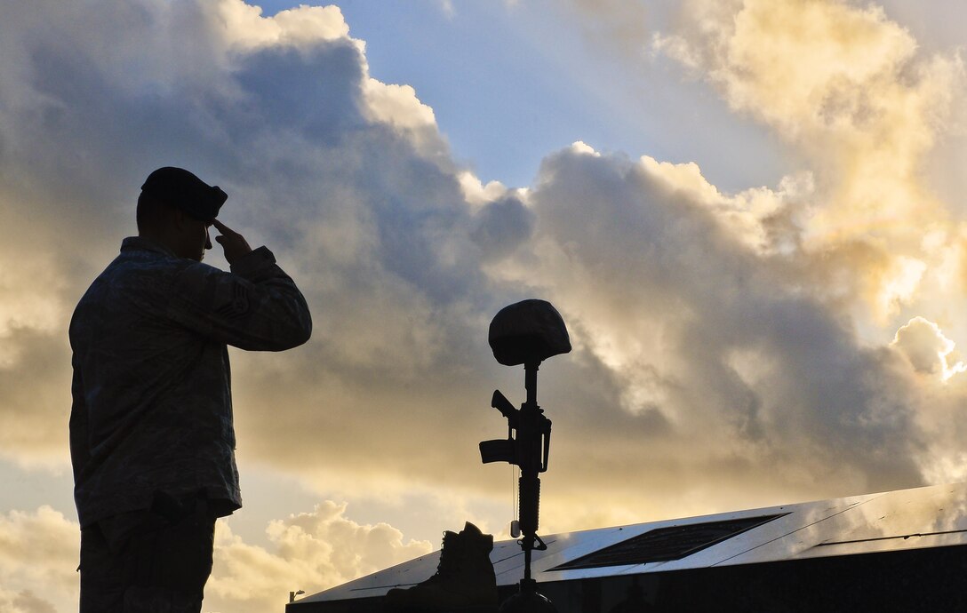 Staff Sgt. Joshua Collins, 36th Security Forces Squadron, salutes a fallen warrior memorial May 19, 2017, Andersen Air Force Base, Guam. Throughout the final day of National Police Week, Airmen honored the fallen. (U.S Air Force photo/Airman 1st Class Christopher Quail)