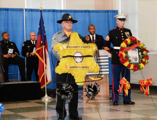 Ken Bevel (second from right), associate pastor, Sherwood Baptist Church, Albany, Ga., guest speaker for the Law Enforcement Memorial Week Ceremony, tells a story and links the analogy to the sacrifices police officers make to the community. The event, which was held at Albany State University’s L. Orene Hall, is an annual observance in commemoration of police officers who died in the line of duty. A capacity crowd of law enforcement officers, family members and local government officials attended the ceremony.
