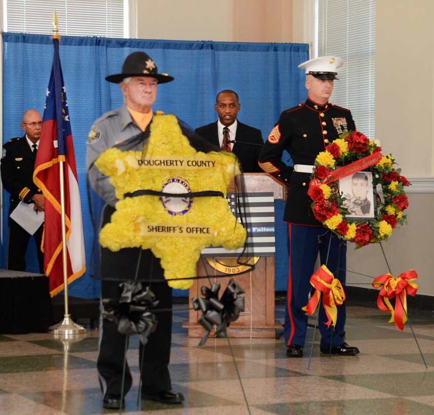 Ken Bevel (center), associate pastor, Sherwood Baptist Church, Albany, Ga., guest speaker for the Law Enforcement Memorial Week Ceremony, tells a story and links the analogy to the sacrifices police officers make to the community. The event, which was held at Albany State University’s L. Orene Hall, is an annual observance in commemoration of police officers who died in the line of duty. A capacity crowd of law enforcement officers, family members and local government officials attended the ceremony.