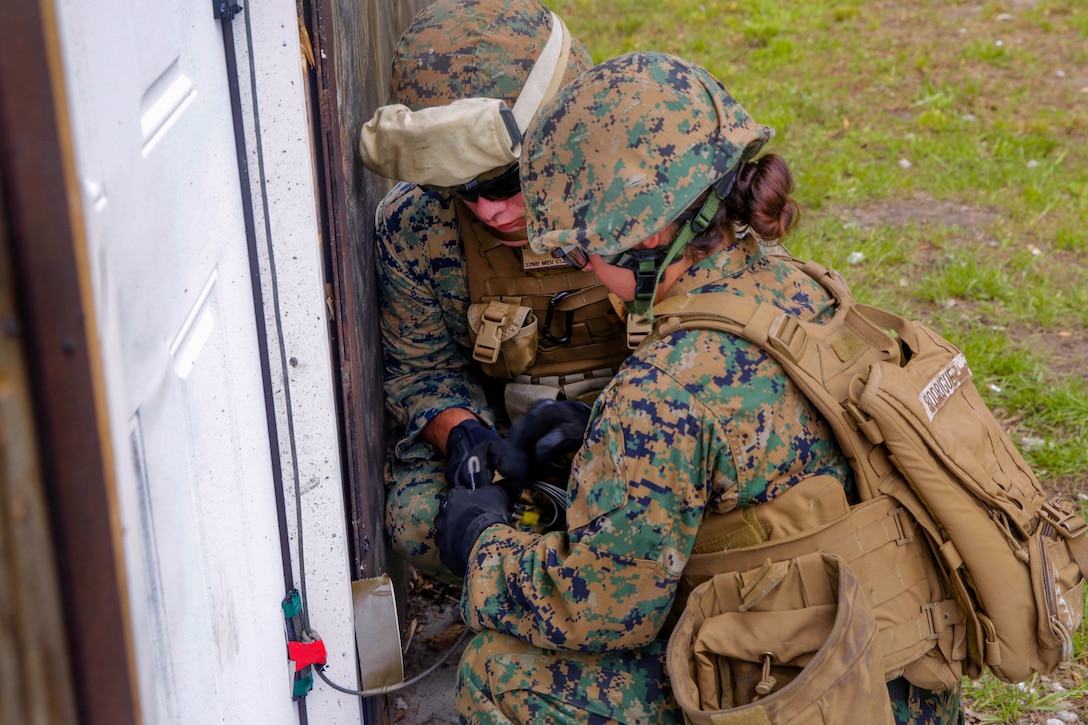 Marines prepare an Uli knot charge on a door during urban breach training at Camp Lejeune, N.C., May 24, 2017. Marine Corps photo by Lance Cpl. Leynard Kyle Plazo