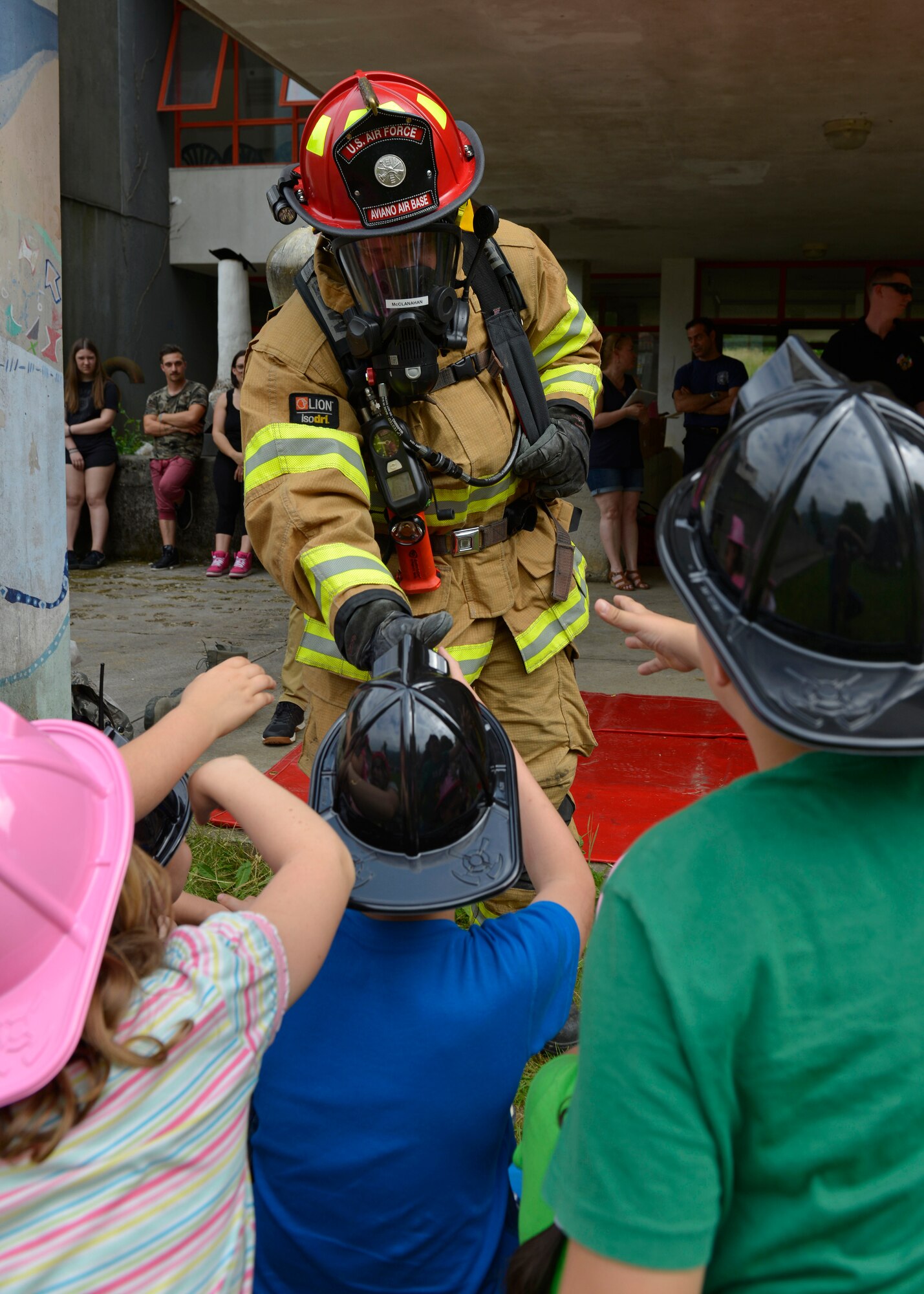 Tech. Sgt. Robert McClanahan, 31st Civil Engineer Squadron lead fire inspector, shakes hands with Italian children, May 31, 2017 at Polcinego, Italy. The children learned about the firefighter’s suits, their equipment and what to do in case of a fire. (U.S. Air Force photo by Senior Airman Cary Smith)